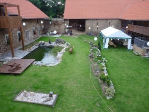 a backyard with a pond and a tent at Statek Kloubek in Chabičovice