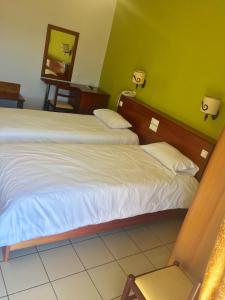 Postel nebo postele na pokoji v ubytování Hotel Olympion