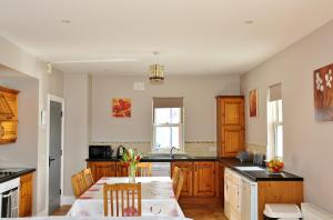 a kitchen with a table and chairs in a room at 11 Doolin Court in Doolin