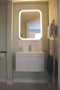 a bathroom with a sink and a mirror at Firbank Lodge in Glenrothes