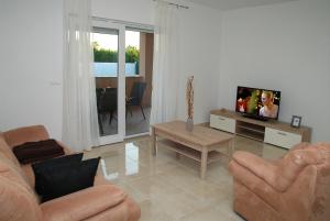 Televízia a/alebo spoločenská miestnosť v ubytovaní Holiday Home Luka