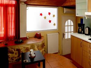 a kitchen with a window with stars on it at Sweet stone apartment in Imittos in Athens +12 photos