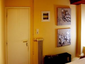 a room with a white door and pictures on the wall at Sweet stone apartment in Imittos in Athens