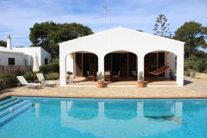 a villa with a swimming pool and a house at Casa con jardín y piscina - MORELL ONZE in Cala Morell