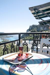 a table with two glasses and a bottle of wine at Belvedere Studios in Kýthira