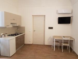 a kitchen with a table and a small table and chairs at Il corso Favignana in Favignana