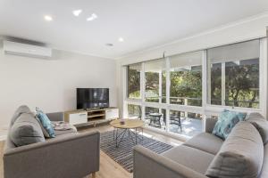 a living room with two couches and a television at Serenity on Tarakan - quiet location near bay in Sorrento