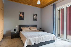 a bedroom with a bed and two pictures on the wall at Cosy 3bedroom Apartment in Sami