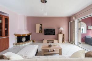 a living room with a couch and a fireplace at Cosy 3bedroom Apartment in Sami