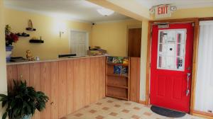 a red door in a kitchen with a counter at Roadway Inn Troy in Troy