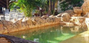 a pool of green water in a rock wall at Hospedaje Solymar II Sarie Bay in San Andrés