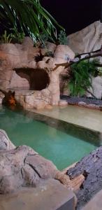 a pool of emerald green water in a zoo at Hospedaje Solymar II Sarie Bay in San Andrés