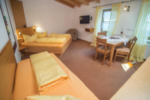 a room with two beds and a table and a couch at Gutshof Colmberg in Colmberg