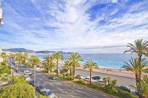 a street with palm trees and a beach at PROMENADE HOLIDAY - AZUR PROMENADE in Nice