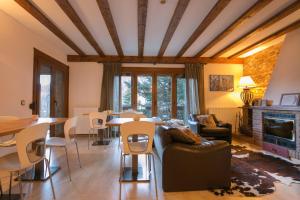 a living room with a couch and a table and chairs at B&B La Lluna in La Massana