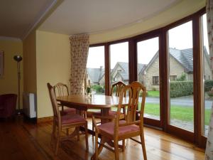 a dining room with a table and chairs and a large window at Galway Bay Lodge in Oranmore