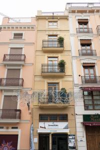 a tall building with balconies on a city street at Victoria Site-Mercat Central in Valencia