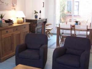 a living room with two chairs and a table at Gîte Mosaïque in Arras