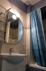 a bathroom with a sink and a mirror at Cozy studio apartment in PIREUS in Piraeus
