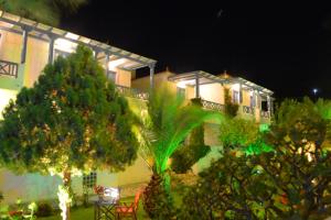 a house with lights on the side of it at Maistrali Studios in Batsi