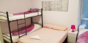 A bed or beds in a room at M&F Apartments Sol