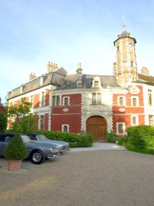 a car parked in front of a large building at Chateau D'aubry in Aubry