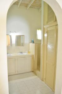 a bathroom with a shower and a sink and a mirror at Top of the World Apartments in Marisule Estate