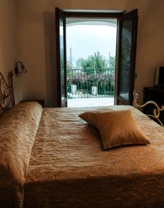 un letto con un cuscino di fronte a una finestra di Il Vigneto a Tramonti