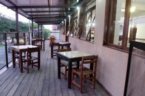 a row of tables and chairs on the porch of a restaurant at Samba Betim in Betim +18 photos