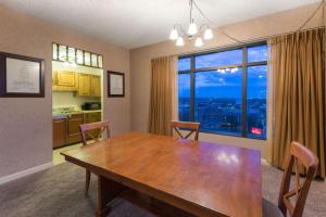 a dining room with a table and a large window at Ramada by Wyndham Topeka Downtown Hotel & Convention Center in Topeka
