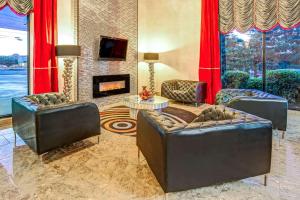 a living room with two couches and a fireplace at Ramada by Wyndham Murfreesboro in Murfreesboro
