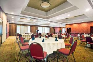a conference room with tables and chairs in a room at Ramada by Wyndham Tukwila Southcenter in Tukwila