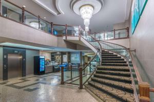 a spiral staircase in a building with a lobby at Ramada Plaza by Wyndham Niagara Falls in Niagara Falls