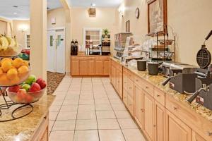 a large kitchen with a bowl of fruit on the counter at Ramada by Wyndham Kittery in Kittery