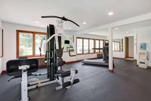 a gym with a treadmill and a elliptical machine at Ramada by Wyndham Flemington in Flemington