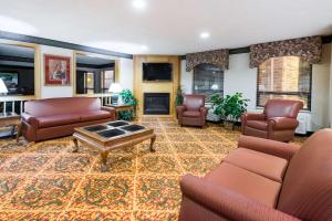 a living room with couches and a coffee table at Ramada by Wyndham Strasburg Dover in Strasburg