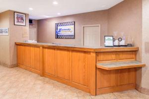 a hair salon with a large wooden counter at Ramada by Wyndham Sparta/At Speedway in Sparta
