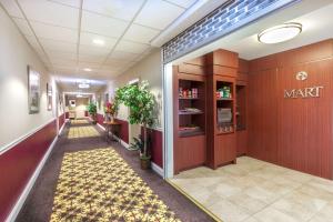 a hallway of a pharmacy with a mart sign on the wall at Ramada by Wyndham Jersey City in Jersey City