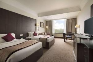 Postel nebo postele na pokoji v ubytování Ramada Plaza by Wyndham JHV Varanasi