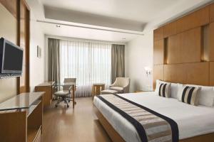 A bed or beds in a room at Ramada By Wyndham Jaipur