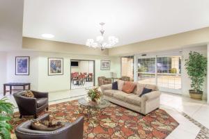 a living room with two couches and a table at Ramada by Wyndham Fresno Northwest in Fresno