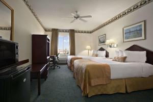 A bed or beds in a room at Ramada by Wyndham Williams