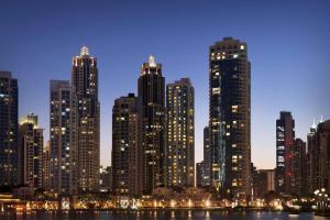 einen nächtlichen Blick auf eine große Stadt mit hohen Gebäuden in der Unterkunft Ramada Downtown Dubai in Dubai