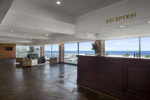 a reception lobby with a view of the ocean at Ramada by Wyndham Jordan/Beacon Harbourside Resort in Jordan