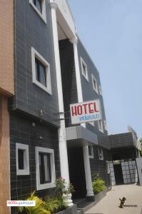 a hotel with a sign on the side of it at Hôtel YABISSO in Lomé