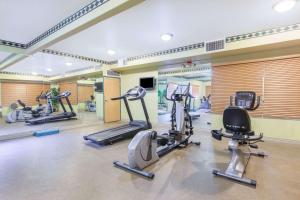 a gym with several treadmills and elliptical machines at Ramada by Wyndham Williams/Grand Canyon Area in Williams