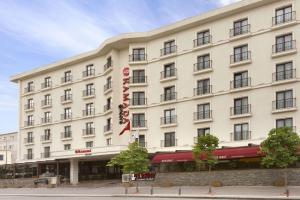 un grande edificio bianco con un cartello sopra di Ramada by Wyndham Istanbul Florya a Istanbul