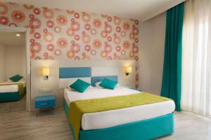 A bed or beds in a room at Ramada Resort Side