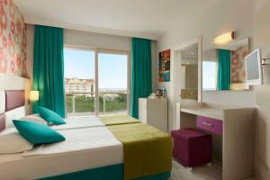 A bed or beds in a room at Ramada Resort Side