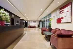 a lobby of a hospital with chairs and a waiting room at Ramada Downtown Abu Dhabi in Abu Dhabi +37 photos